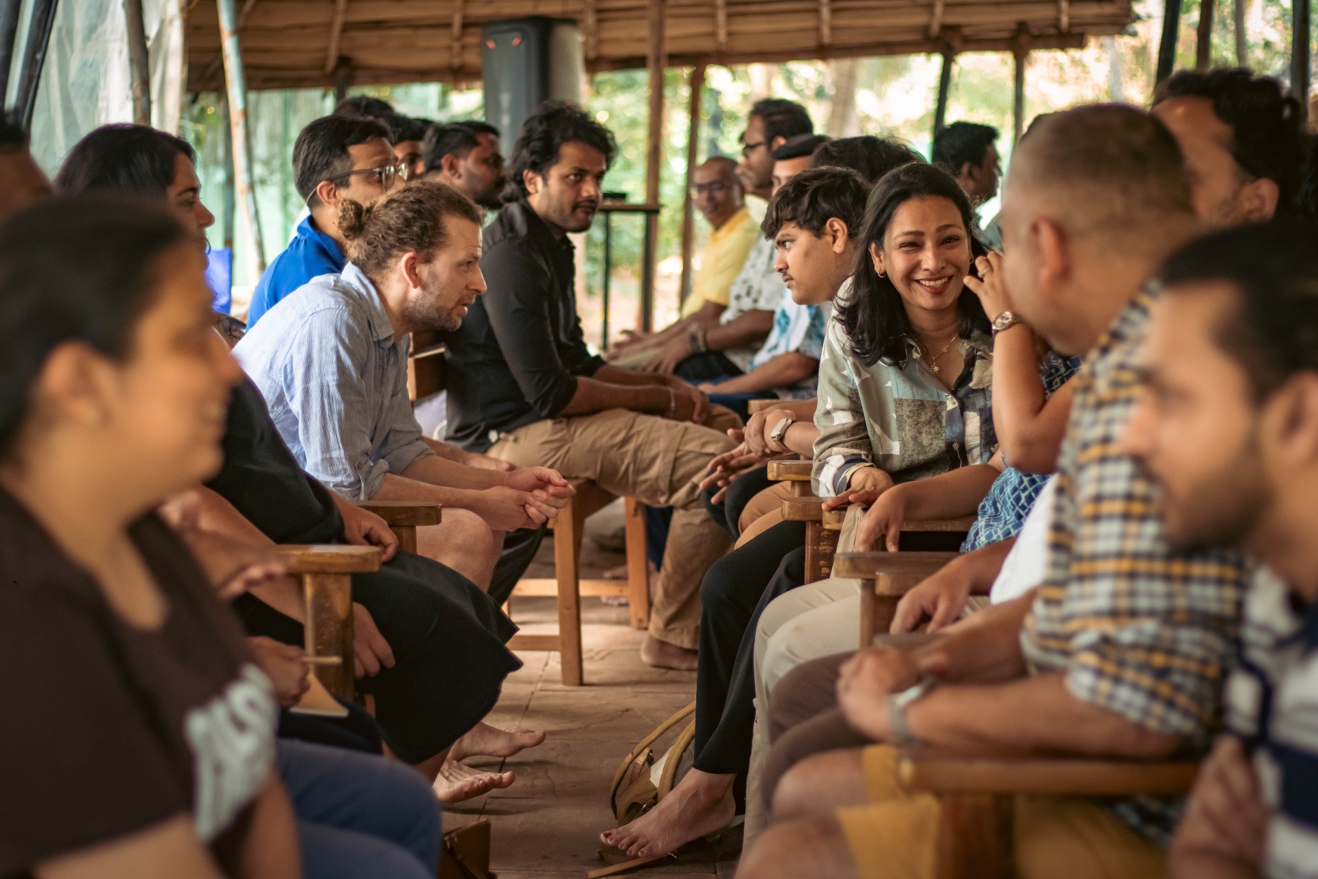 cohort gathered under a thatched pavilion